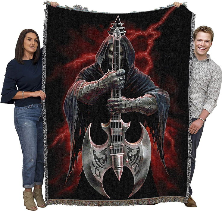 Two adults holding up skeleton tapestry blanket to show large size