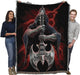 Two adults holding up skeleton tapestry blanket to show large size