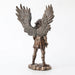 Saint Michael the archangel clad in battle armor with sword and shield and feathered wings. Shown from the back