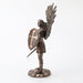 Saint Michael the archangel clad in battle armor with sword and shield and feathered wings. Shown from the side