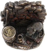 A cat wearing a pentacle sits upon a stack of thick leather-bound books. Next to the feline is a broom and bubbling cauldron, spiderweb, chalice, and athame dagger with a rose. A brick backdrop completes the piece. View from the top looking down into the chalice, showing papers under the vessel, rose and athame