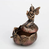 Trinket box in faux metal featuring a mother and baby fairy on a flower with a dragonfly. Shown partially open