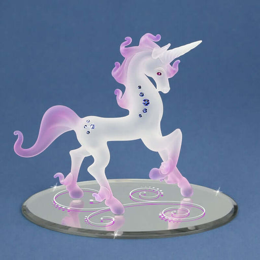 Frosted glass unicorn from Glass Baron. Has a white frosted body with purple pink mane, tail, and feet. Blue crystals adorn the body and there are pink crystal eyes. It stands prancing on a mirror basae with pink and white swirl patterns.