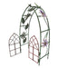 A tiny gate meant for a fairy garden, made of metal in a trellis arbor shape with a floral motif