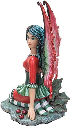Fairy Figurine in red and green with holly leaves and berries, by artist Amy Brown. Side view. 