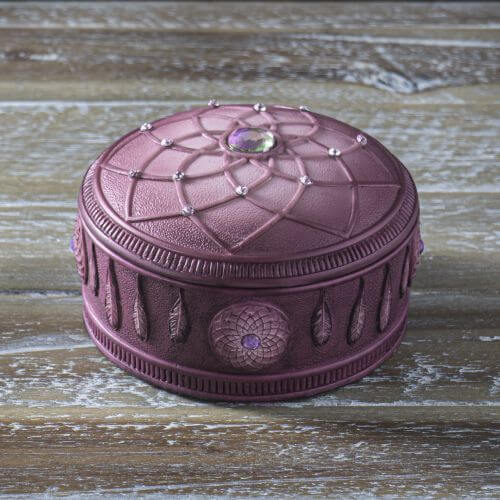 Pink-purple dreamcatcher themed trinket box accented with jewels. Shown on a wooden table