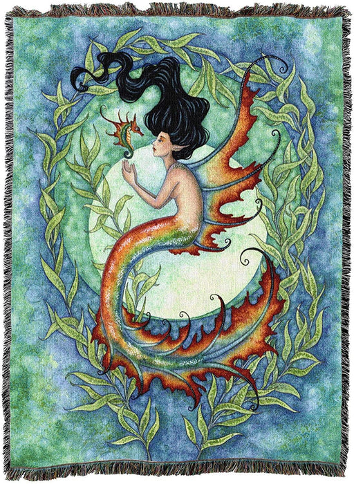 Amy Brown artwork on a tapestry blanket of a mermaid in rust, green and teal with black hair. She swims with a sea dragon in a seaweed swirl with a full moon in the background