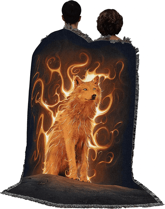 Blanket shown held up by two people, wolf on fire on a black background