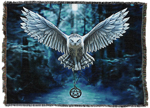 Tapestry blanket with art by Anne Stokes showing a white snowy owl flying through a winter landscape with a pentacle necklace in its talons