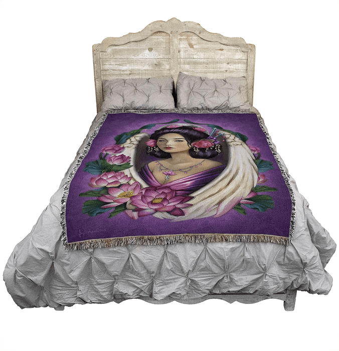 Lotus Angel tapestry blanket by Brigid Ashwood shown displayed on a bed with a wooden headboard