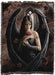 Tapestry blanket with art by Anne Stokes showing a black feather winged angel holding a red rose in the falling autumn leaves, with a Gothic window behind. 