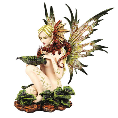 Fairy figurine with naked fairy. Pixie has vine tattoos and green wings and reddish dragon perched on her shoulder, drinking from a leaf with water in it