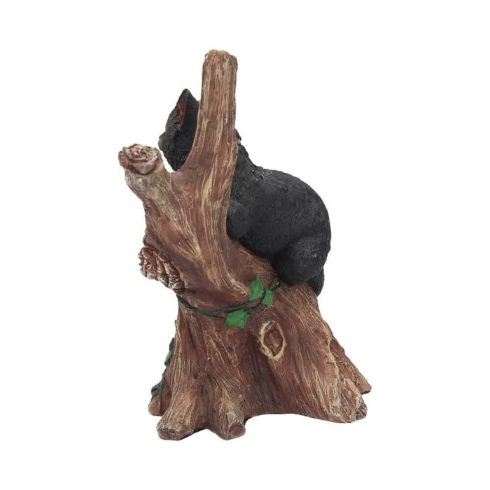 Side view of tree with black cat