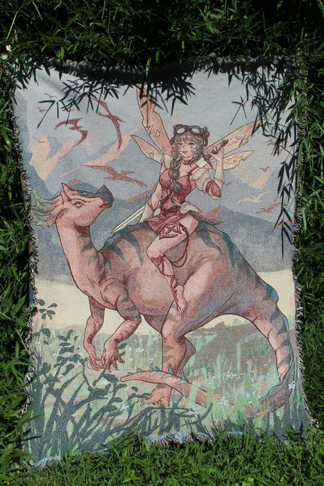 Fairy and dinosaur woven tapestry shown hung outside in sunlight