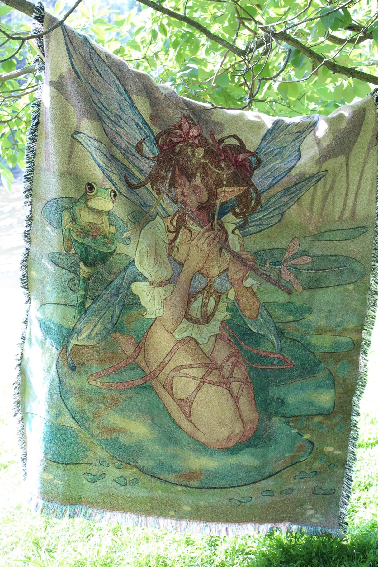 Fairy playing the flute tapestry blanket hanging outside