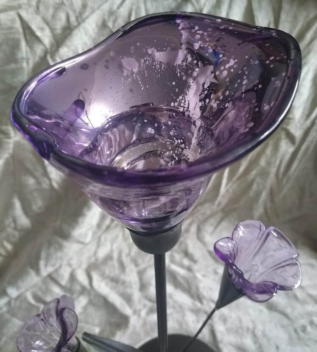 Closeup of mottled purple glass tealight holder, shaped like a flower