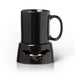 Black glossy ceramic mug warmer with a bat cutout, warming a matching black coffee mug on top