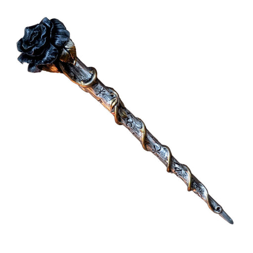 A wand carved with sigils and topped with a black rose flower