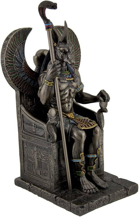 Anubis the Egyptian god with Jackal head sitting in throne with snake scepter
