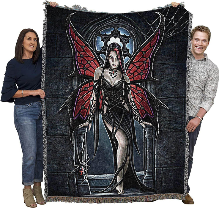 Arachnafaria tapesrtry blanket held up to show size next to two adults