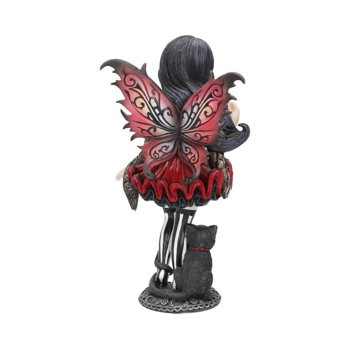 Back view - Pixie figurine wearing black and maroon holding a pumpkin. A black cat sits next to the fairy.