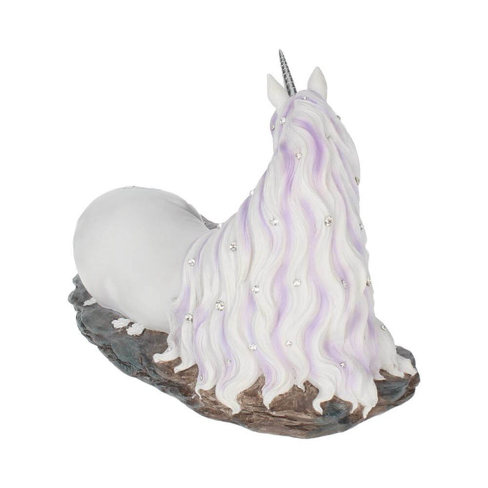 White unicorn with jewels in mane and tail laying down near blue-purple crystals, back view showing mane with crystals
