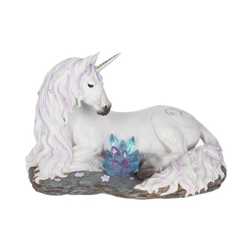White unicorn with jewels in mane and tail laying down near blue-purple crystals