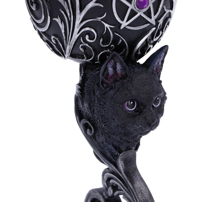 Detail of black cat on goblet stem with purple eyes.