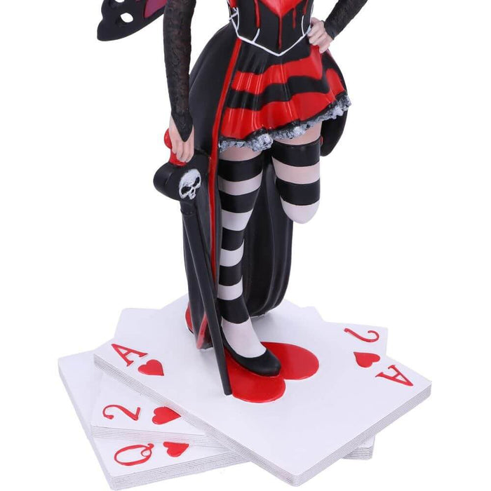 Queen of Hearts figurine - fairy with red and black dress, white and black stockings, red, purple and black wings standing on playing cards. Closeup of her legs, cane, and playing cards Ace, Two, and Queen of Hearts