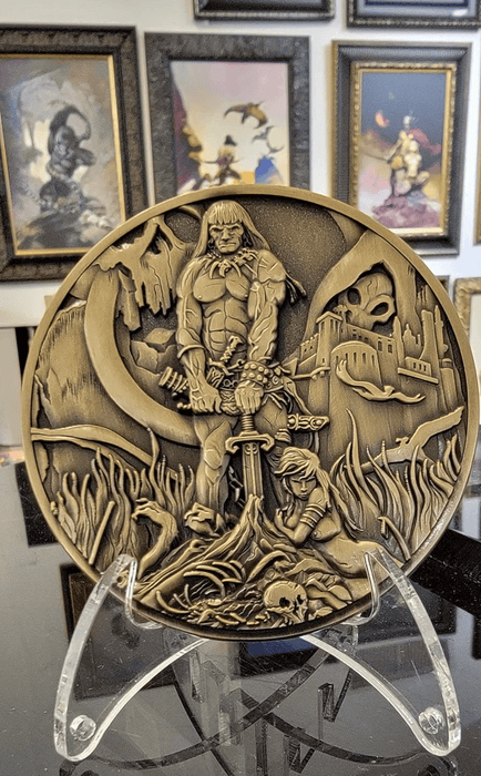 Barbarian coin shown on stand in front of artwork