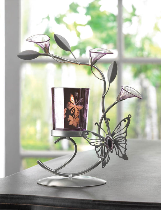 Butterfly and lily candle holder shown lit on a table