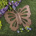 Cast iron butterfly stepping stone, shown on a lawn with purple flowers