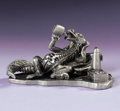 Pewter figurine of a dragon drinking coffee, next to a carafe