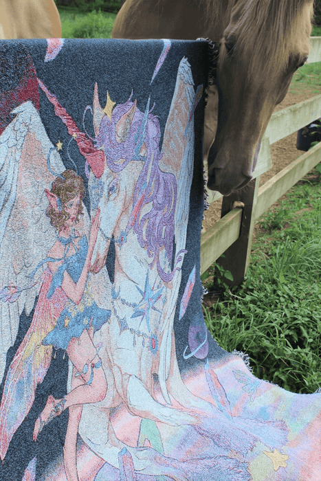 Cosmic fairy and unicorn blanket shown outside with horse for scale