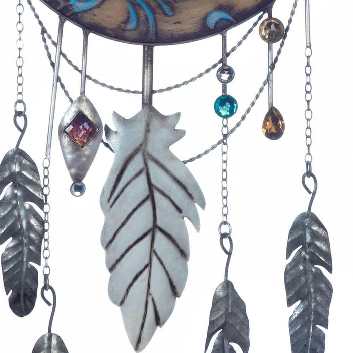 Closeup of the sparkling, colorful jewels and feathers hanging from the wall decor