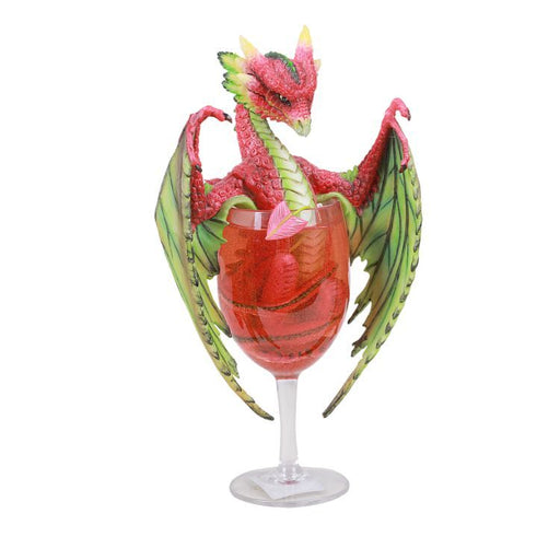 A red and green dragon sits half-submerged in a white glass of translucent resin strawberry daiquiri