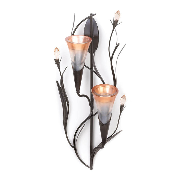 Lily flower candle holders surrounded by golden faceted flower budss and dark metal stems and leaves