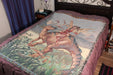 Fairy and dinosaur tapestry displayed on a bed