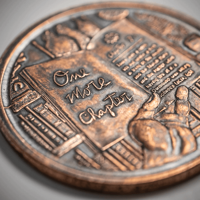 One More Chapter side of the coin detail showing text and books with hand