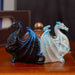 Black and white dragons around a gold lid for this trinket box. Shown on a wooden table