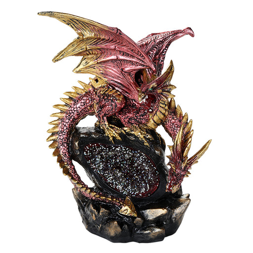 Dragon figurine of red dragon with gold accents on top of a crystal gem