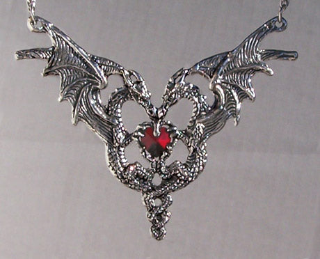 two dragons shaped into hear form holding a gem necklace