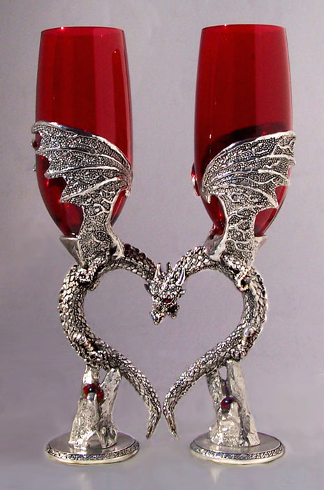 two dragon wedding wine flutes that are nuzzling and positioned to form a heart inlayed with gems.