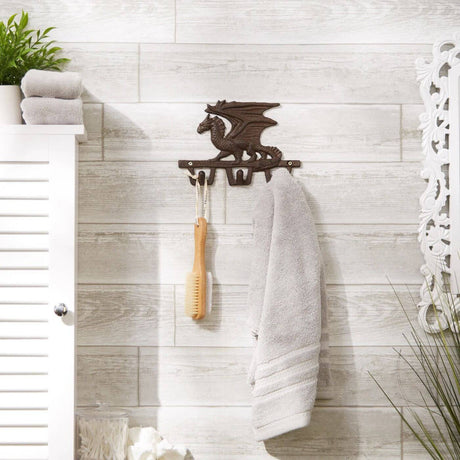 Metal dragon wall hook shown in a bathroom holding a towel and shower brush