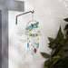 Dragonfly wind chime hanging against a white wall