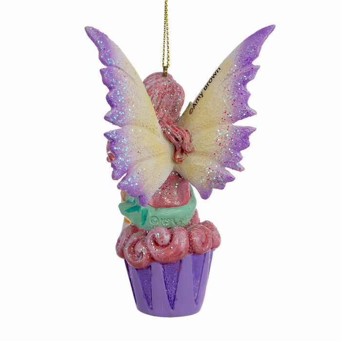 Back view of Amy Brown fairy ornament with pixie sitting on a cupcake, wearing pink, green, orange and white.