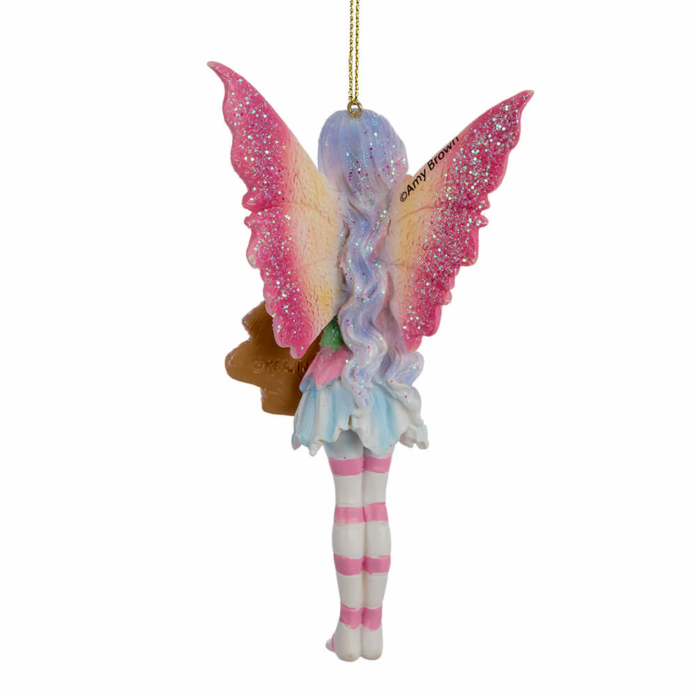 Back view of Amy Brown fairy ornament with pixie in pink, green, yellow, blue and white holding a Christmas tree cookie.