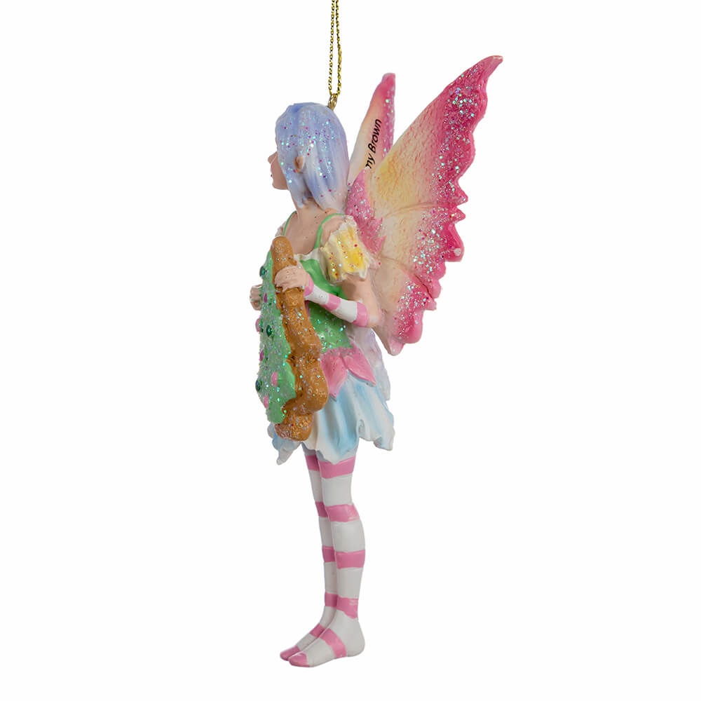 Side view of Amy Brown fairy ornament with pixie in pink, green, yellow, blue and white holding a Christmas tree cookie.