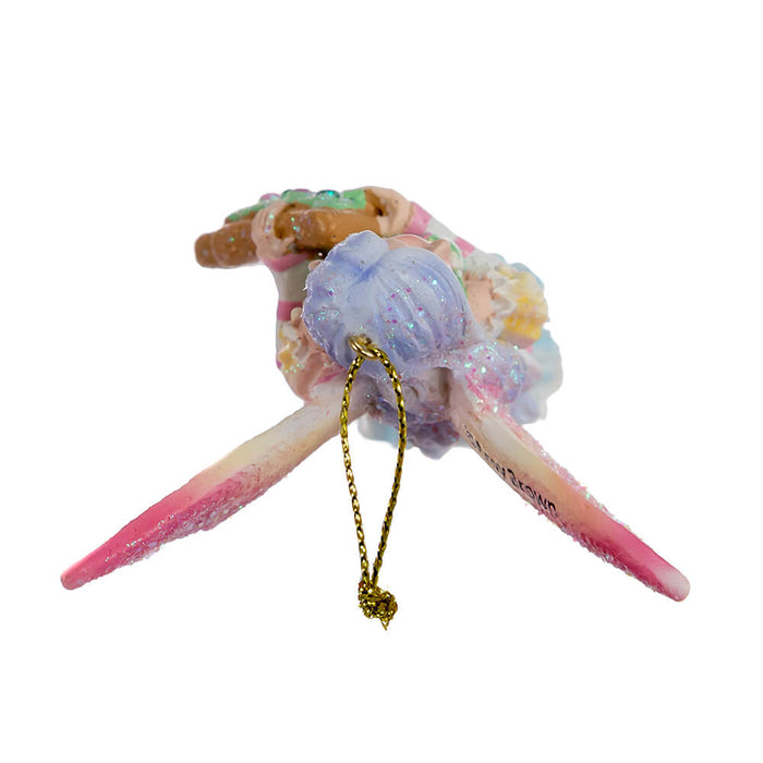 Top down view of Amy Brown fairy ornament with pixie in pink, green, yellow, blue and white holding a Christmas tree cookie.