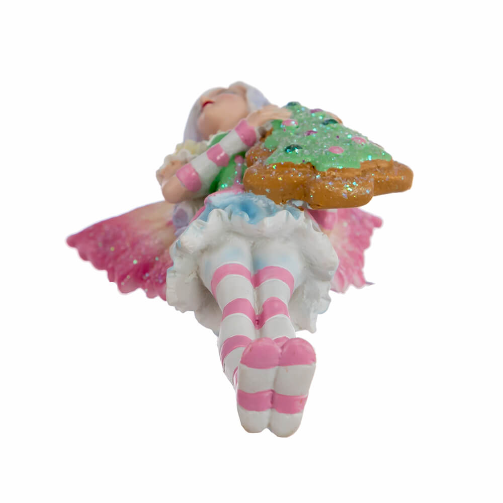 Bottom view of Amy Brown fairy ornament with pixie in pink, green, yellow, blue and white holding a Christmas tree cookie.